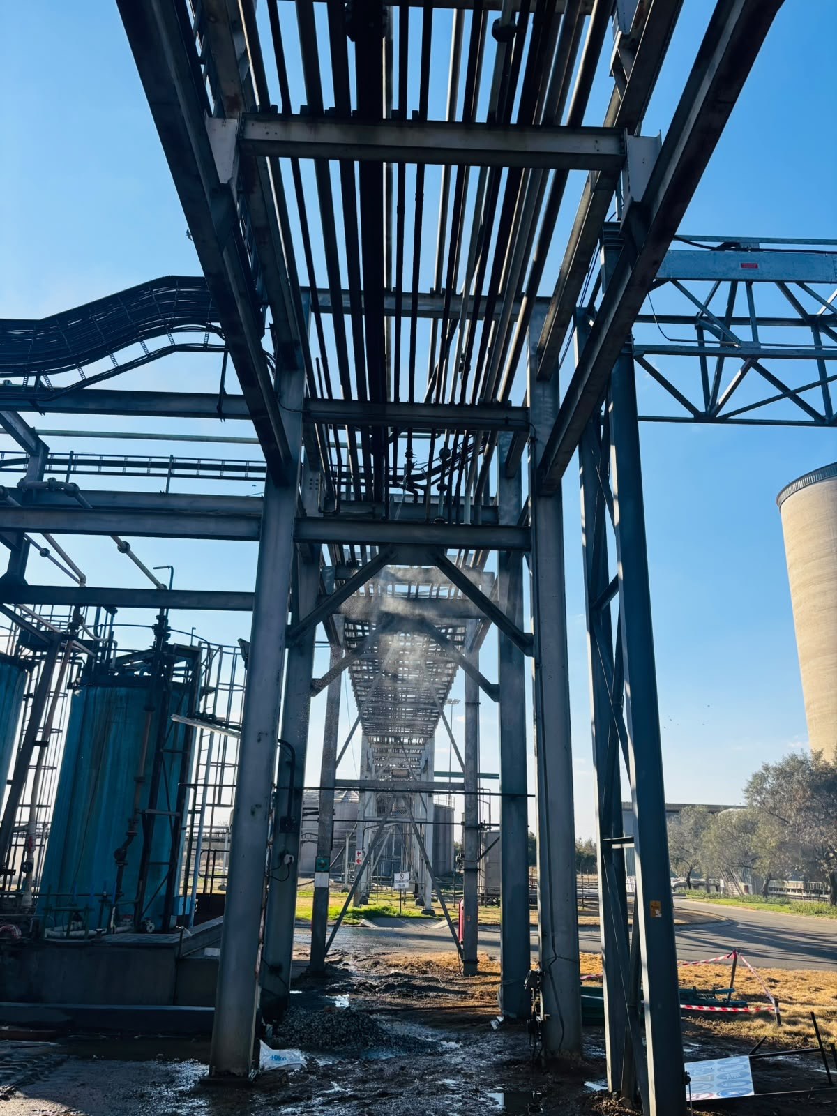 UrbanEdge technicians working on industrial pipe rack structure